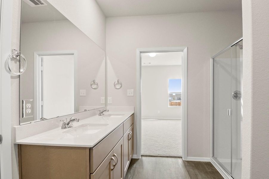 *Representative photo* A dual vanity with ample counter space and elegant cabinetry provides plenty of room for two, with large mirrors and modern lighting that make the space feel bright and open. *Representative photo* A dual vanity with ample counter space and elegant cabinetry provides plenty of room for two, with large mirrors and modern lighting that make the space feel bright and open.