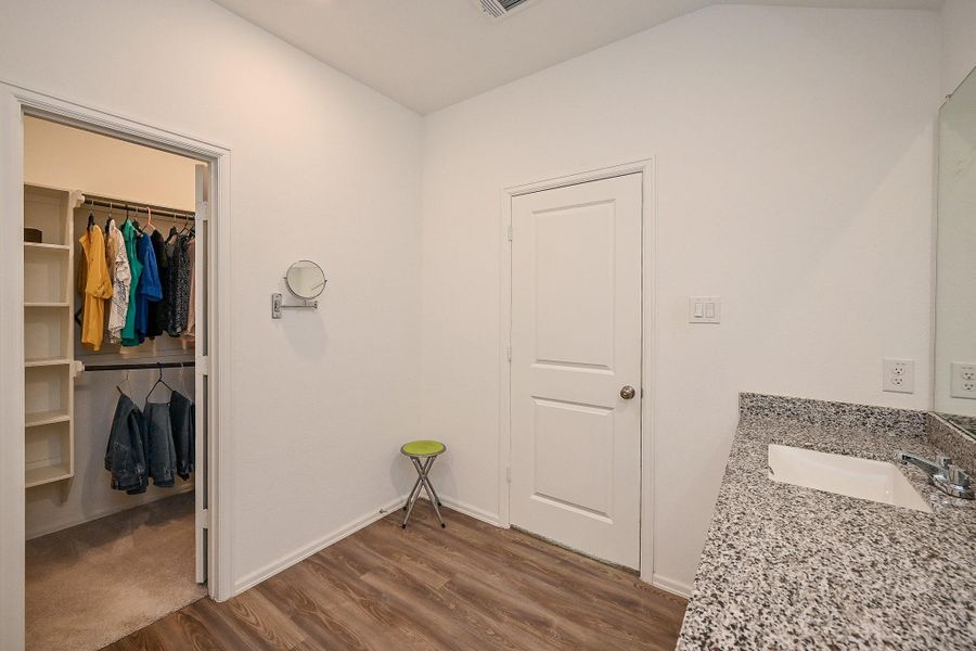 A walk-in closet outfitted with organized hanging racks and shelving—perfect for effortless wardrobe management. A walk-in closet outfitted with organized hanging racks and shelving—perfect for effortless wardrobe management.