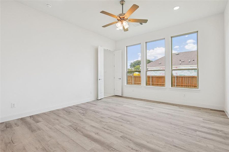 Spare room with ceiling fan and light hardwood / wood-style floors