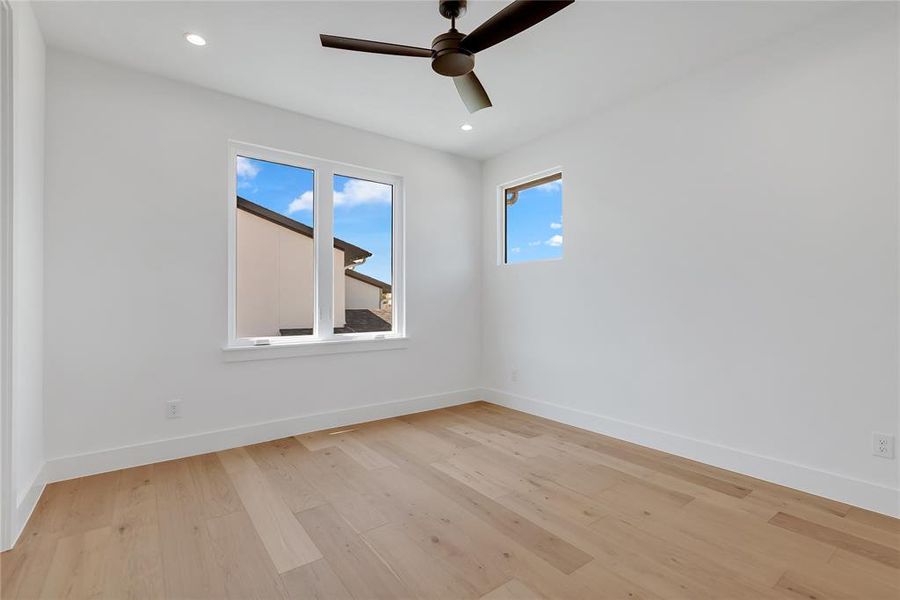 Spare room featuring a ceiling fan, light wood finished floors, and recessed lighting Spare room featuring a ceiling fan, light wood finished floors, and recessed lighting