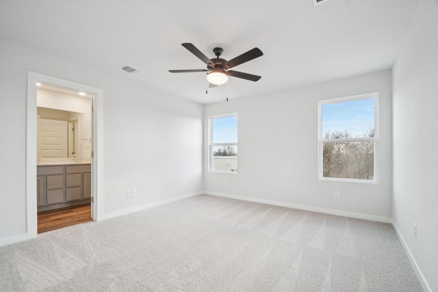 A room with a ceiling fan and a window.