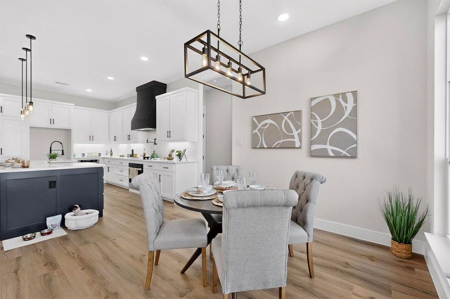 Dining area featuring light wood-style flooring and recessed lighting