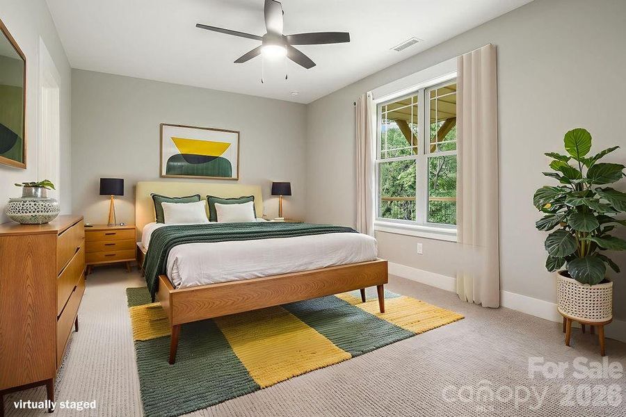 Lower level 4th bedroom with ceiling fan and walk-in closet.