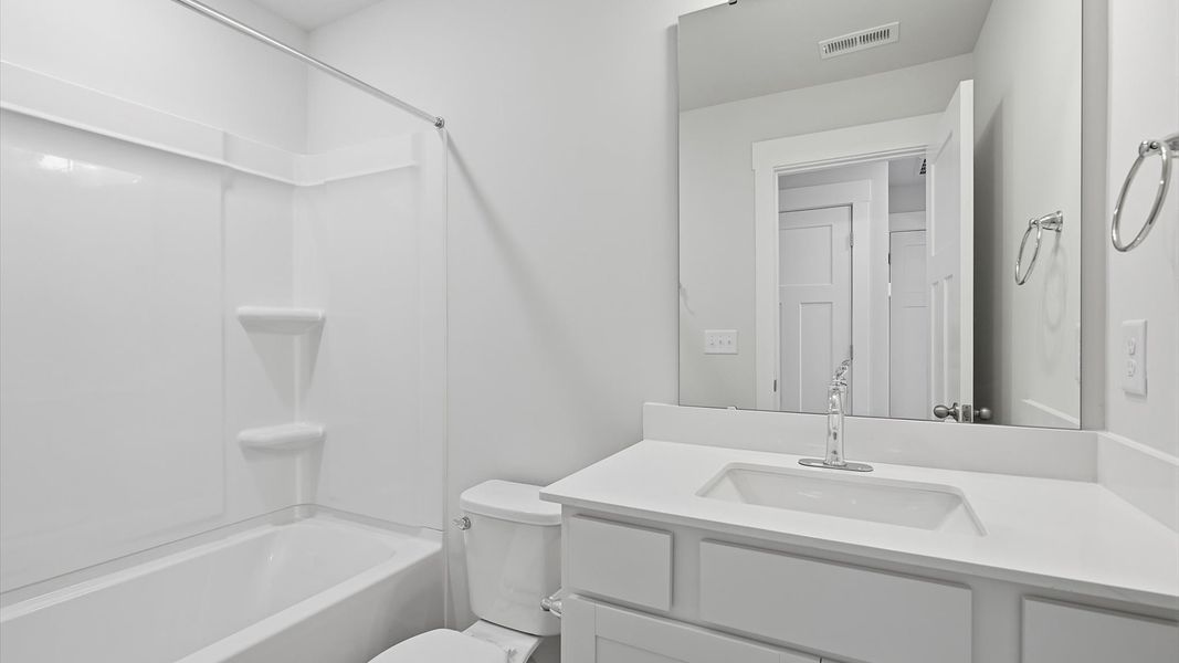 Vibrant and welcoming bathroom with elegant countertop space and polished details at Clarke Townes Vibrant and welcoming bathroom with elegant countertop space and polished details at Clarke Townes