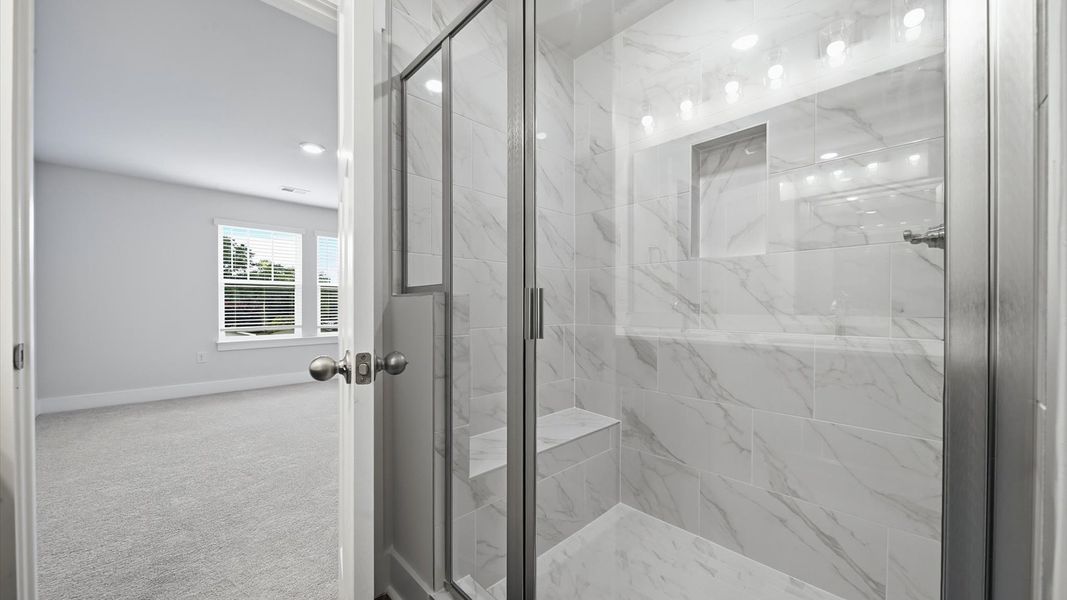 Accomplished design shines in this primary bath with dual vanity and a sleek walk-in shower at Saluda Crossing Accomplished design shines in this primary bath with dual vanity and a sleek walk-in shower at Saluda Crossing