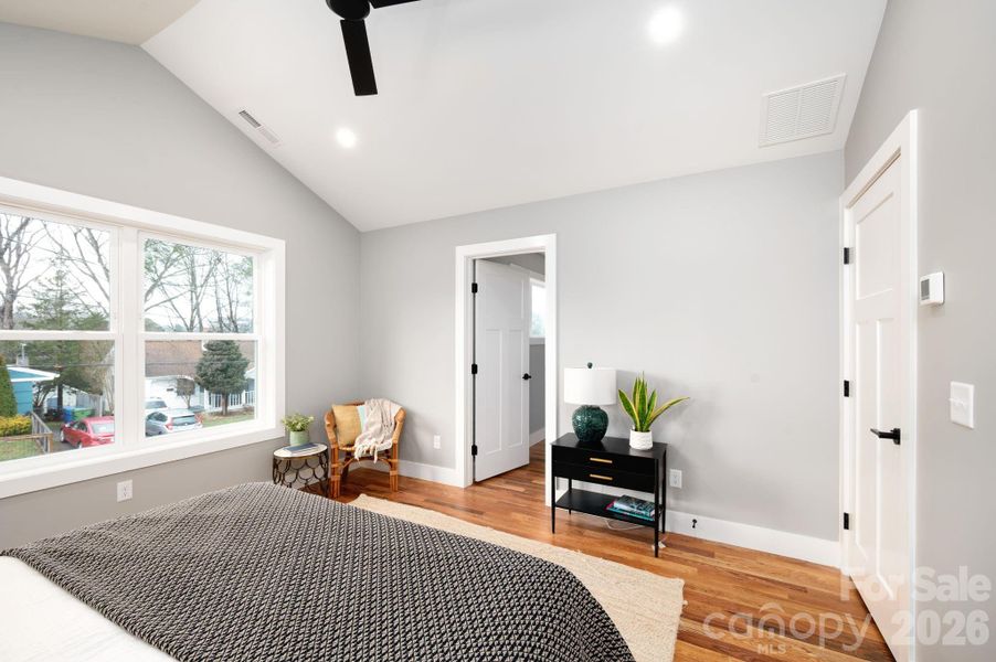 Spacious Primary Suite Features a Vaulted Ceiling and Full Bath