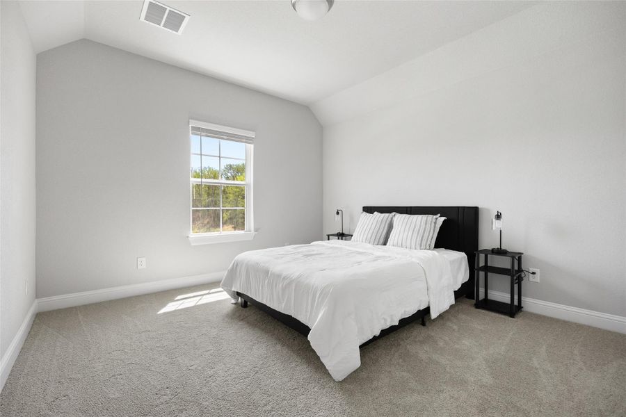 Spacious secondary bedroom located on 2nd floor with carpet, high ceilings, ceiling fan, and walk in closet