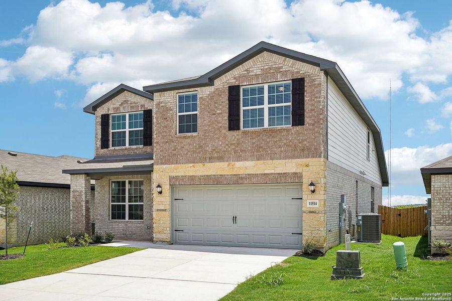 Front exterior of a new home in Sagebrooke - Premier Series, San Antonio, TX, highlighting curb appeal (Image 26). Front exterior of a new home in Sagebrooke - Premier Series, San Antonio, TX, highlighting curb appeal (Image 26).