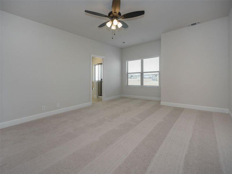 Spare room featuring light carpet and a ceiling fan Spare room featuring light carpet and a ceiling fan