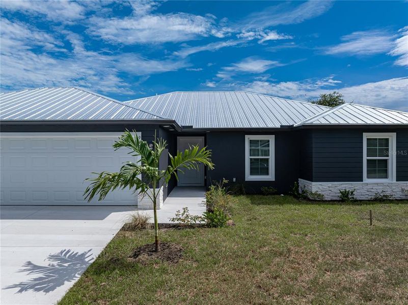 Front exterior of a new home in , Englewood, FL, highlighting curb appeal (Image 24).