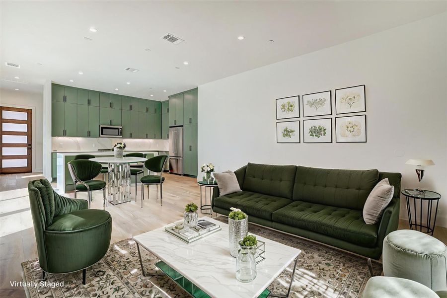 Living room featuring light wood finished floors and recessed lighting