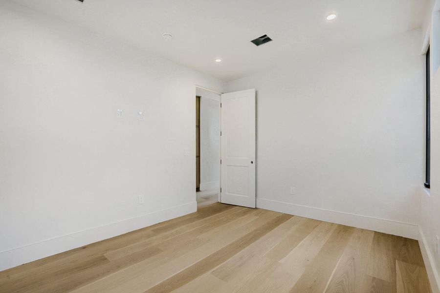 Blonde hardwood floors extend through this ample room, offering a neutral foundation for personalized style.