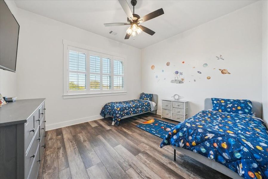 Bedroom featuring dark wood-style floors and ceiling fan