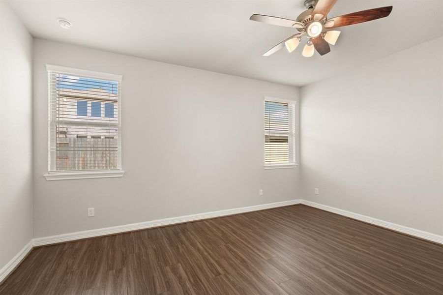 The primary bedroom is generously sized, creating a tranquil and spacious retreat that offers ample room for relaxation. Featuring sleek floors, high ceilings, fresh paint, and large windows that lets in natural lighting throughout the day.