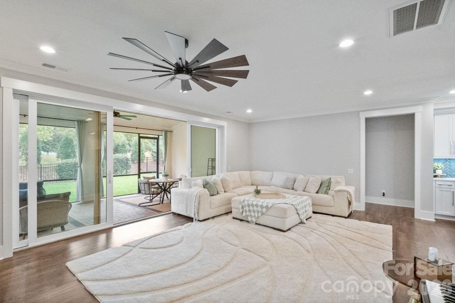 Large living space with modern fireplace and sliding doors to outdoor screen patio