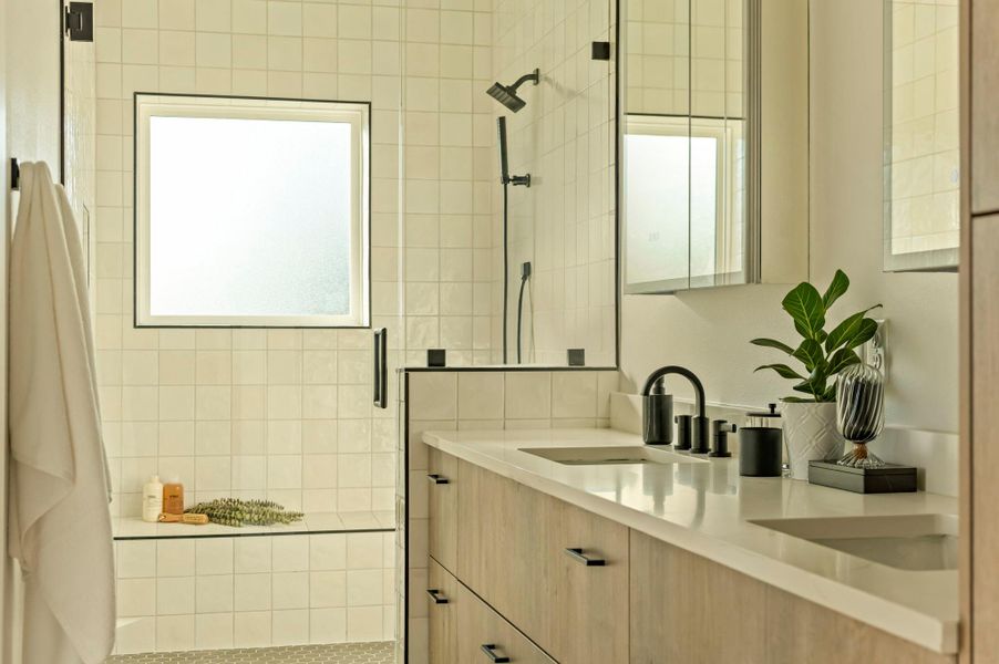 Bathroom with a stall shower, double vanity, and plenty of natural light Bathroom with a stall shower, double vanity, and plenty of natural light