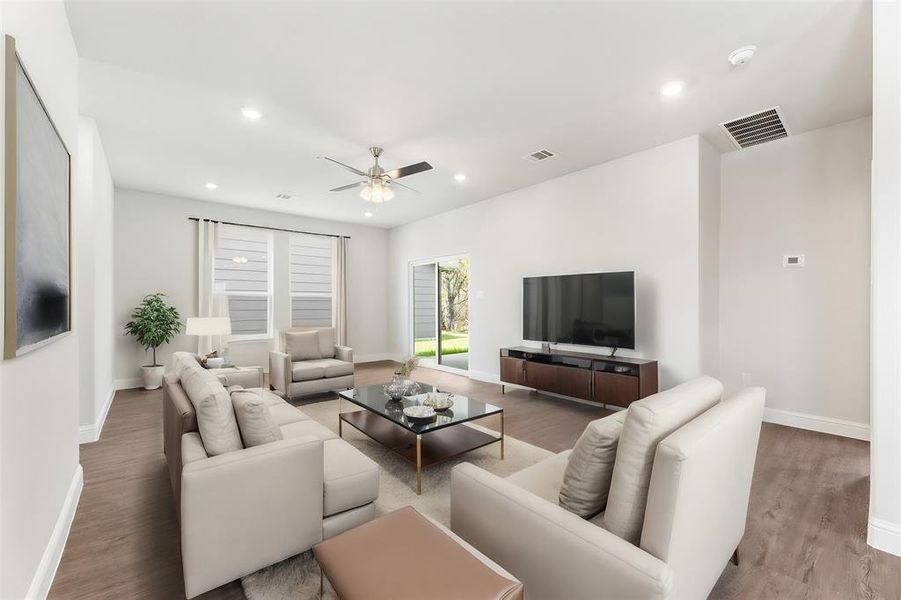 Living room featuring ceiling fan and wood-type flooring