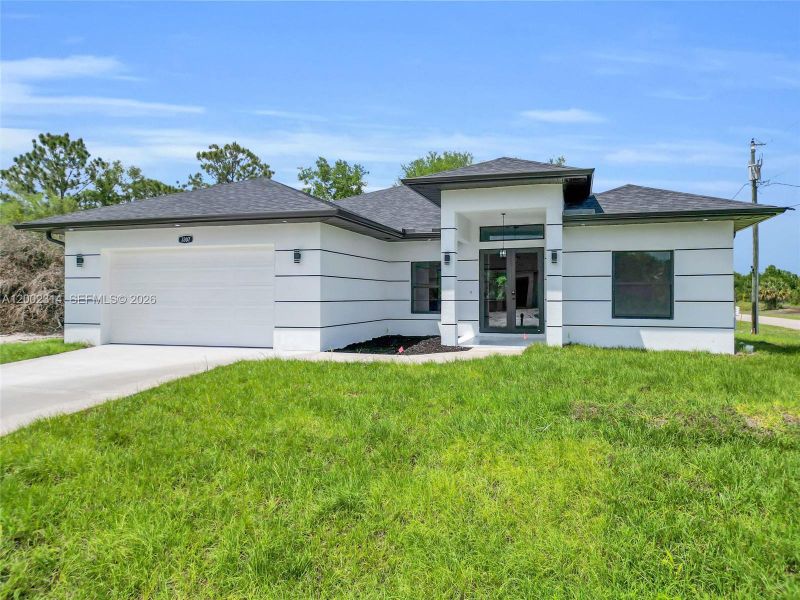 Front exterior of a new home in , Lehigh Acres, FL, highlighting curb appeal (Image 17).