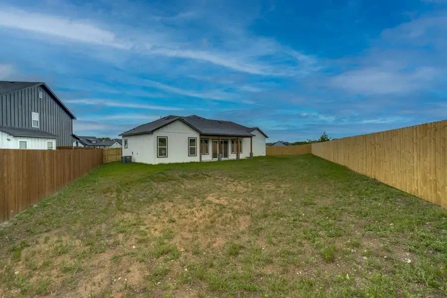 Expansive backyard with a new privacy fence Expansive backyard with a new privacy fence