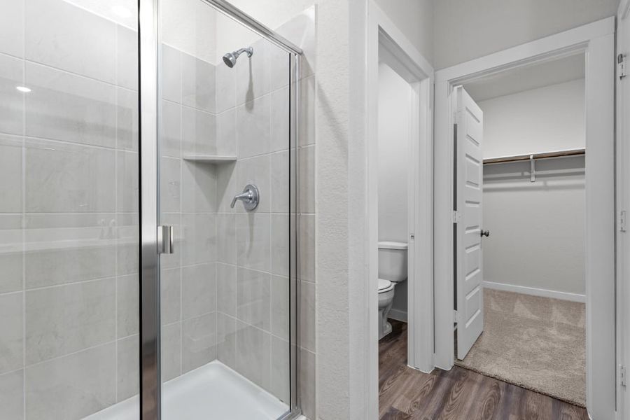 A bathroom with a glass shower. A bathroom with a glass shower.