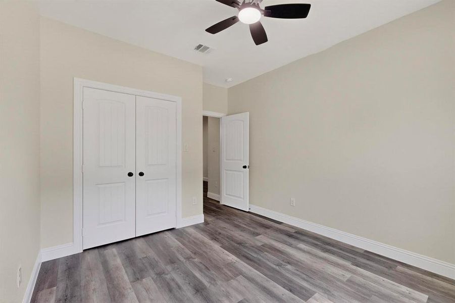 Unfurnished bedroom featuring light wood-style floors, a ceiling fan, and a closet Unfurnished bedroom featuring light wood-style floors, a ceiling fan, and a closet