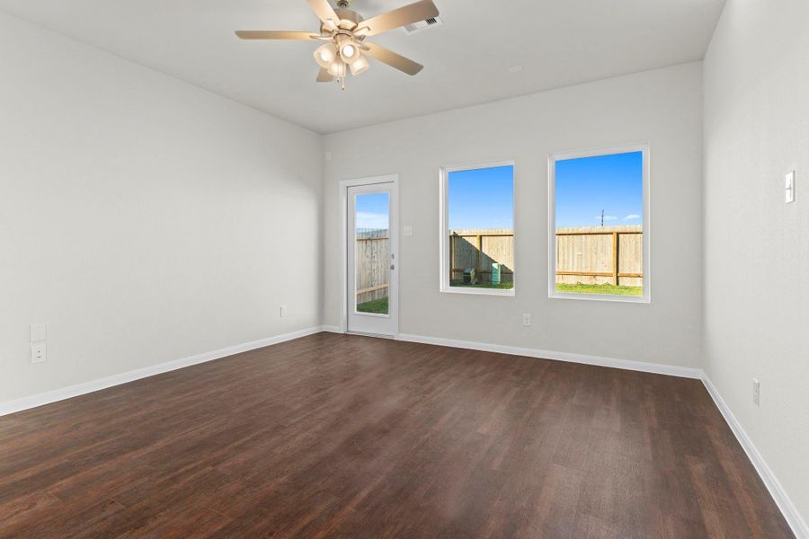 Another view of the inviting family room showcasing its open flow into the dining and kitchen areas. The bright, airy atmosphere and high ceilings create a sense of comfort and connection throughout the home. Another view of the inviting family room showcasing its open flow into the dining and kitchen areas. The bright, airy atmosphere and high ceilings create a sense of comfort and connection throughout the home.