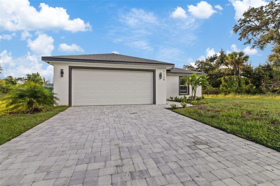 Front exterior of a new home in , Port Charlotte, FL, highlighting curb appeal (Image 13).
