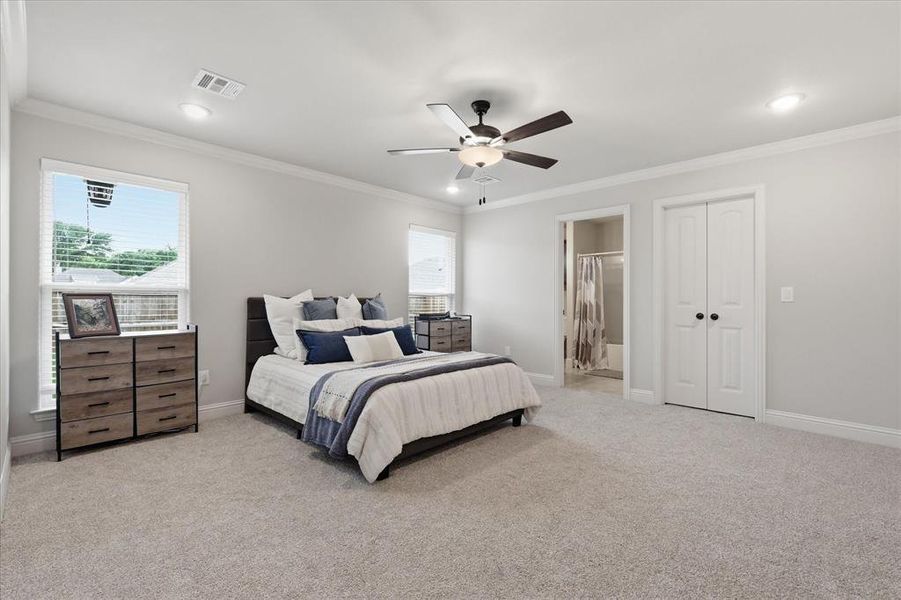 Spacious primary bedroom featuring a private ensuite bath for added comfort and convenience.