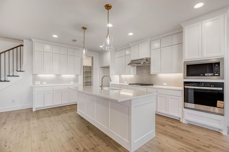 Kitchen with stainless steel appliances and white cabinets