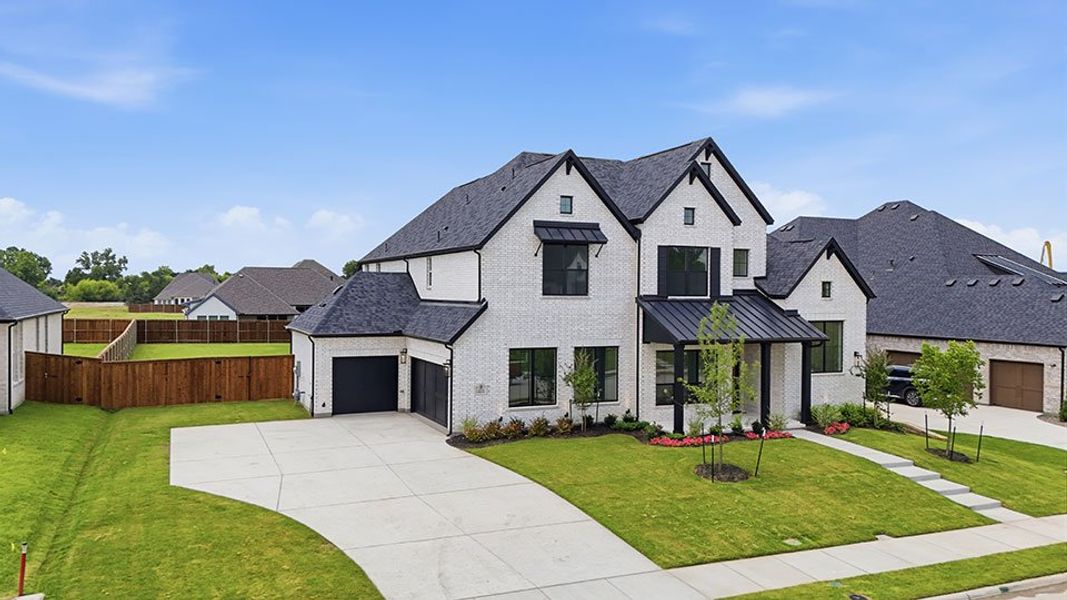 Front exterior of a new home in Winding Creek, Rockwall, TX, highlighting curb appeal (Image 26). Front exterior of a new home in Winding Creek, Rockwall, TX, highlighting curb appeal (Image 26).