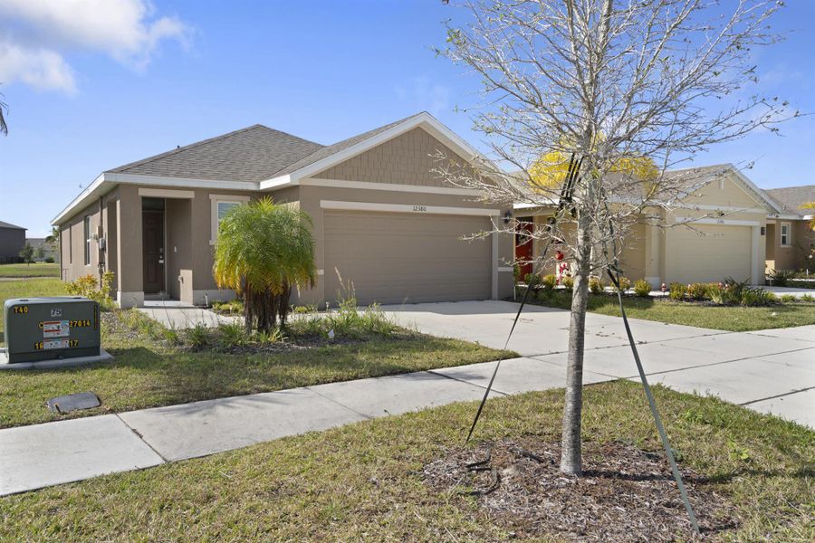 Front exterior of a new home in Central Park 40s, Port St. Lucie, FL, highlighting curb appeal (Image 2).