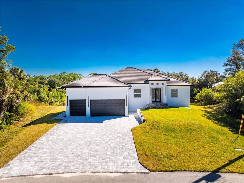 Front exterior of a new home in , Port Charlotte, FL, highlighting curb appeal (Image 1). Front exterior of a new home in , Port Charlotte, FL, highlighting curb appeal (Image 1).