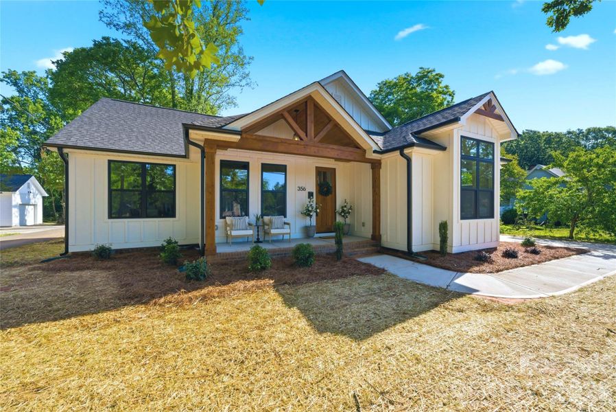 Modern farmhouse charm meets timeless small-town living in the heart of McAdenville. Featuring striking timber accents, black windows, an inviting covered front porch, and beautiful architectural details, this move-in-ready home offers warmth, character, and curb appeal from the moment you arrive.