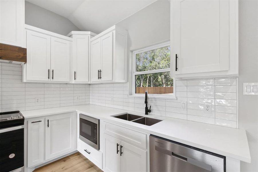 Full bathroom with toilet, hardwood / wood-style flooring, tiled shower / bath combo, and vanity