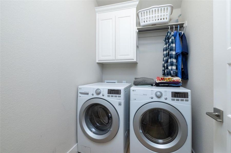 Washroom with cabinet space and separate washer and dryer