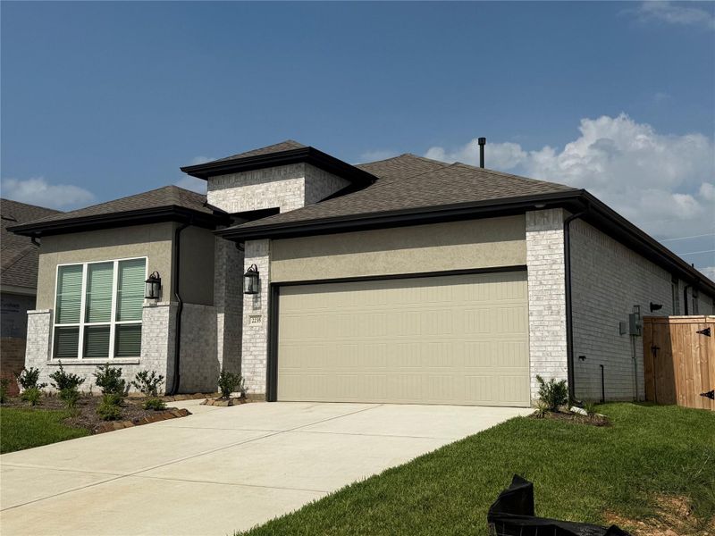 Front exterior of a new home in Wood Leaf Reserve, Tomball, TX, highlighting curb appeal (Image 2).
