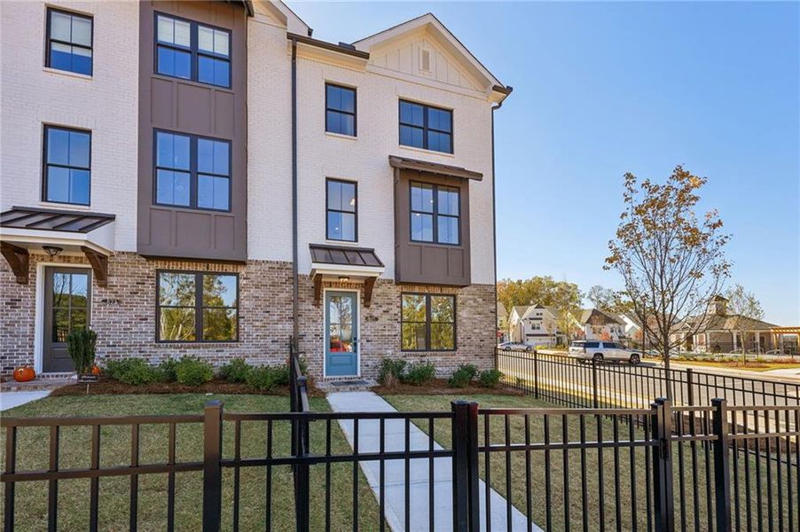 Front exterior of a new home in Palisades Townhomes, Cumming, GA, highlighting curb appeal (Image 22).