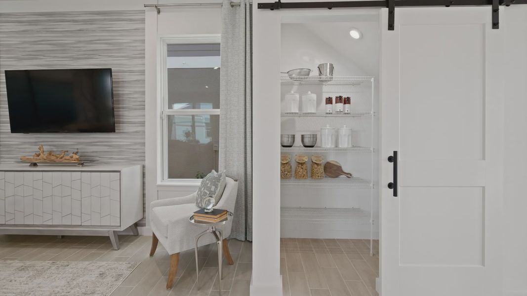 Kitchen pantry with barndoor at a DRB Homes Ambersweet model at the Trinity Place community. Kitchen pantry with barndoor at a DRB Homes Ambersweet model at the Trinity Place community.
