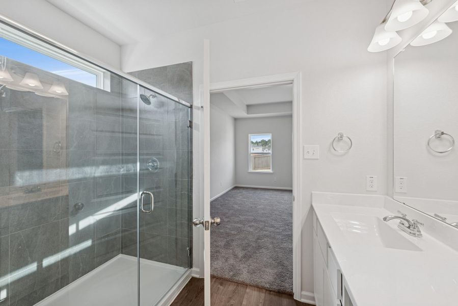 The Crawford- Primary Bathroom with Dual Vanities and Walk-In Shower The Crawford- Primary Bathroom with Dual Vanities and Walk-In Shower