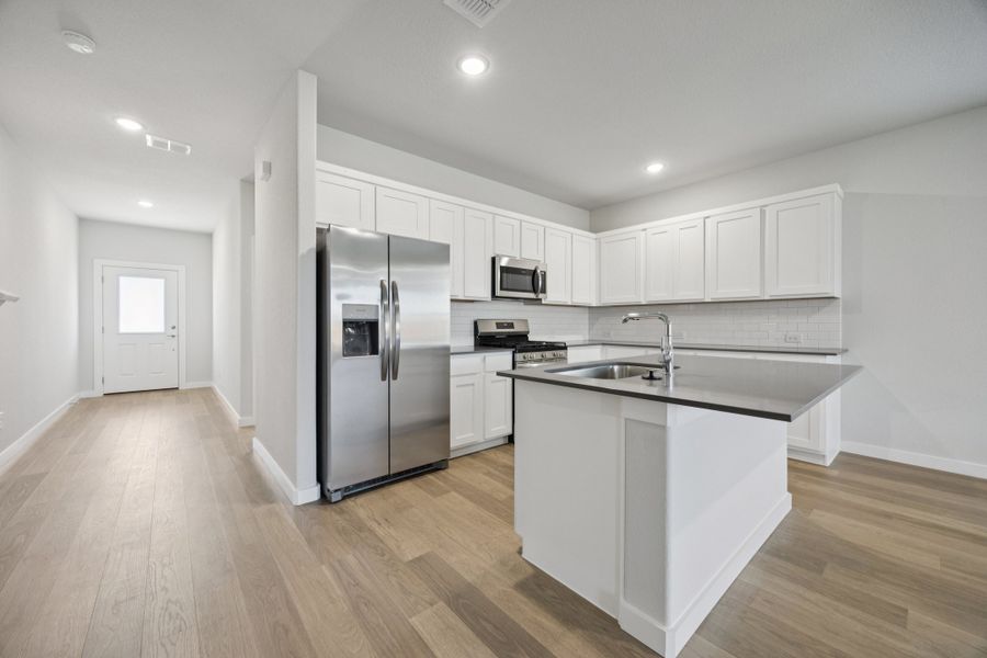 Kitchen in the Haylee home plan by Trophy Signature Homes - REPRESENTATIVE PHOTO Kitchen in the Haylee home plan by Trophy Signature Homes - REPRESENTATIVE PHOTO