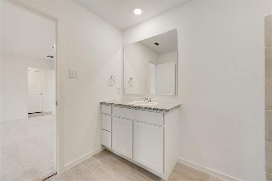 Bathroom with vanity and hardwood / wood-style floors