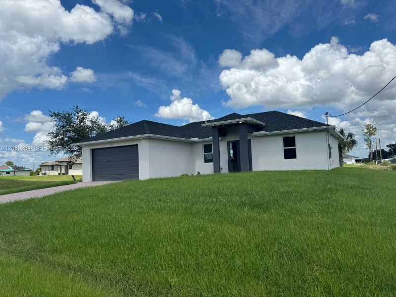 Front exterior of a new home in , Lehigh Acres, FL, highlighting curb appeal (Image 2). Front exterior of a new home in , Lehigh Acres, FL, highlighting curb appeal (Image 2).