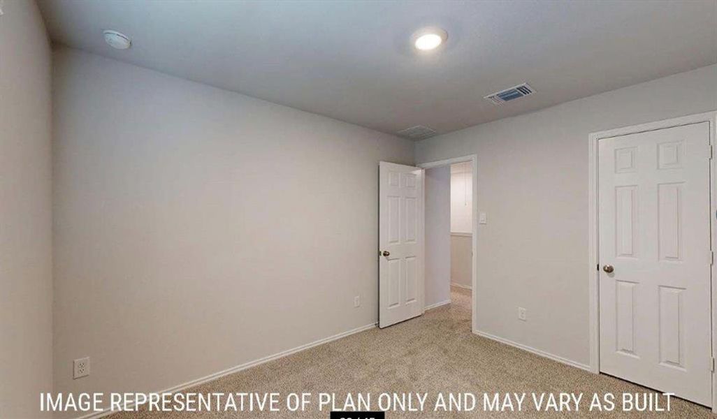 Carpeted room with light neutral wall paint, recessed lighting, and white six-panel interior doors Carpeted room with light neutral wall paint, recessed lighting, and white six-panel interior doors