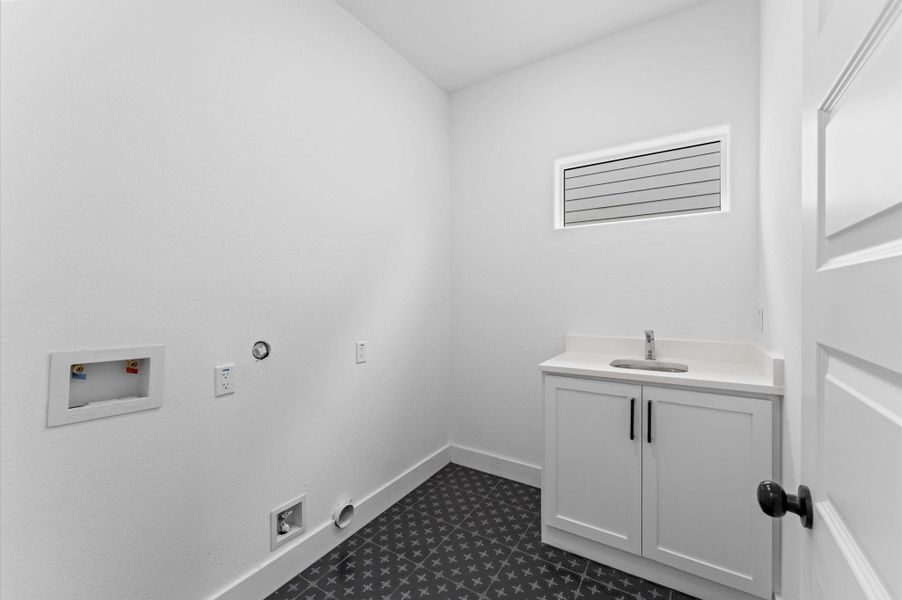 This indoor utility room, located upstairs by the bedrooms, is ready to hold a full-sized washer and dryer.