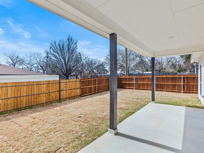 View of yard featuring a fenced backyard and a patio area