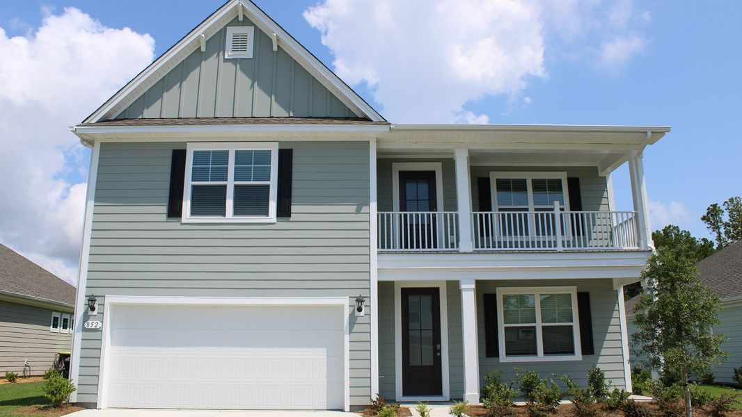 Front exterior of a new home in The Bluffs at Mill Creek, Florence, SC, highlighting curb appeal (Image 1). Front exterior of a new home in The Bluffs at Mill Creek, Florence, SC, highlighting curb appeal (Image 1).