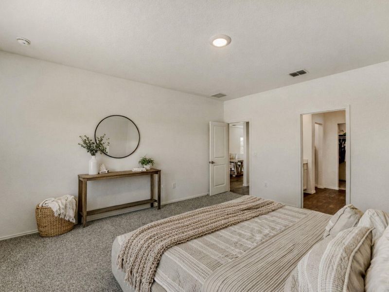 Bedroom with carpet floors and ensuite bathroom