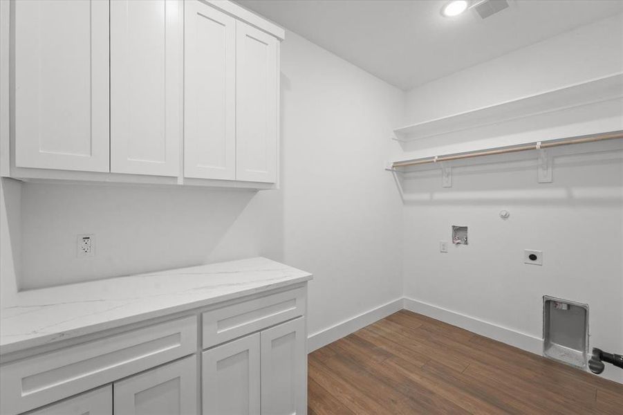 Laundry room featuring cabinets, washer hookup, gas dryer hookup, electric dryer hookup, and dark hardwood / wood-style floors