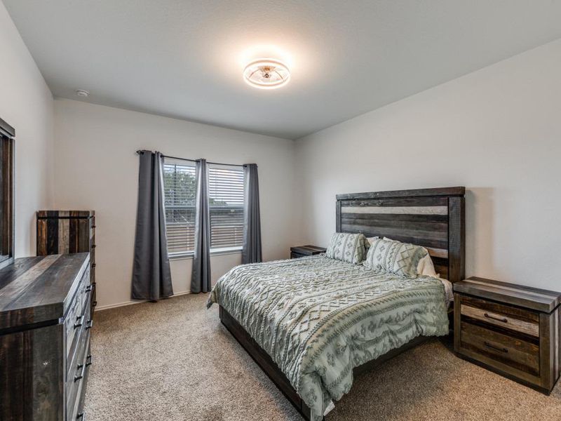 Carpeted bedroom with baseboards