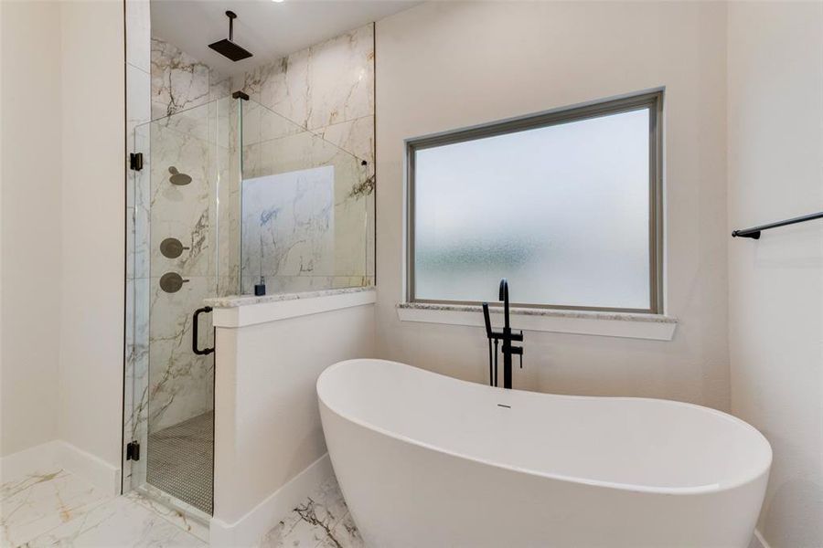 Full bathroom with a soaking tub, a marble finish shower, and marble finish flooring Full bathroom with a soaking tub, a marble finish shower, and marble finish flooring